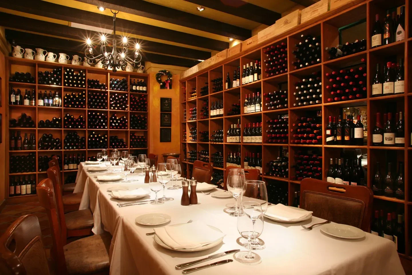 Cozy dining area at CinCin Ristorante Bar in Vancouver, featuring a wine wall.