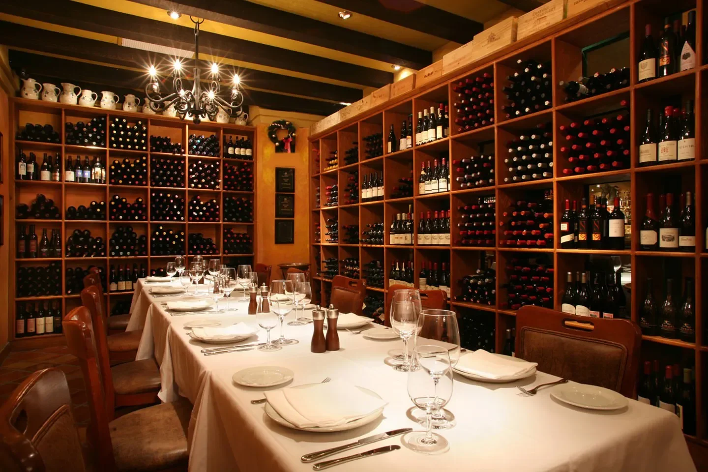 Cozy dining area at CinCin Ristorante Bar in Vancouver, featuring a wine wall.