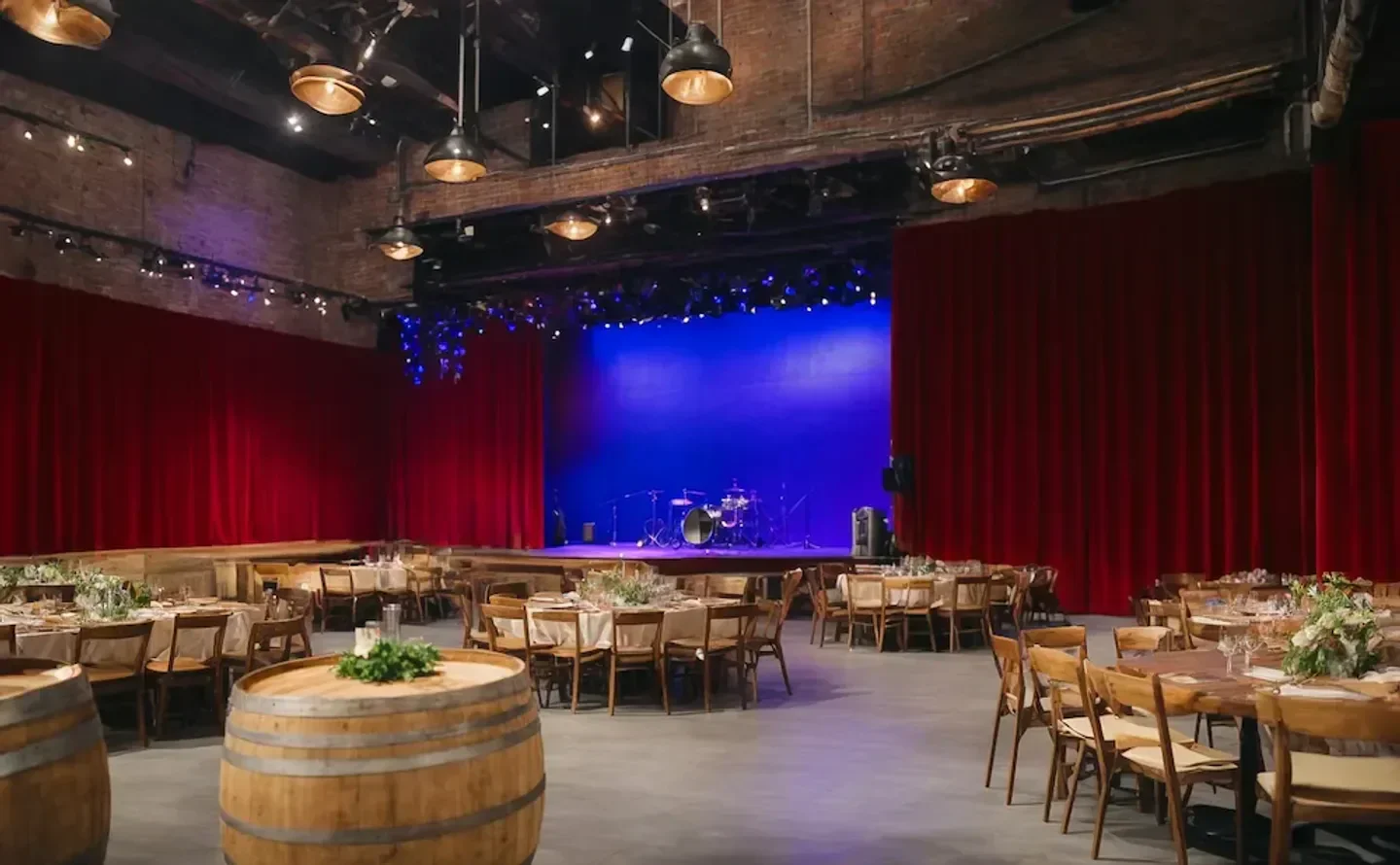 Interior of City Winery Boston, Boston, with stage and tables set for dining.