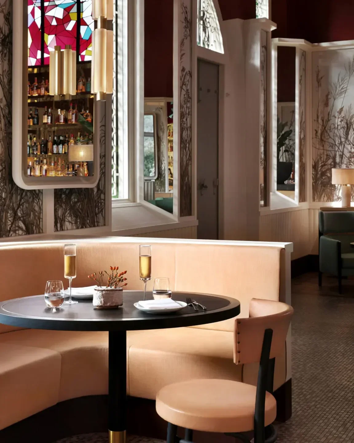 Cozy dining area at Claudine restaurant in Singapore, featuring a stylish booth and table setting.