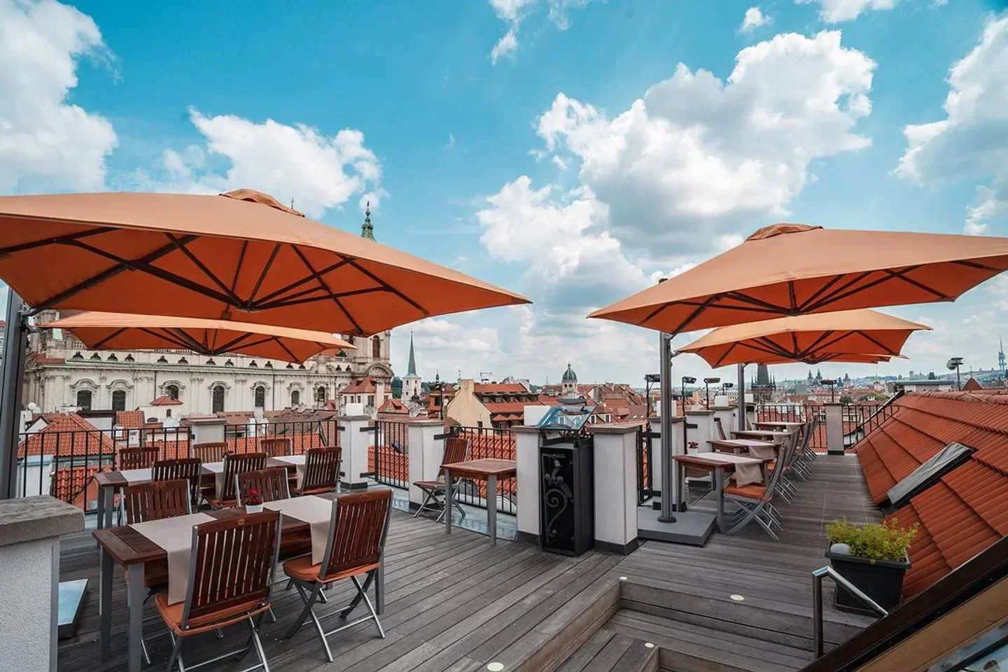 Rooftop terrace at CODA Restaurant in Prague with city views and orange umbrellas