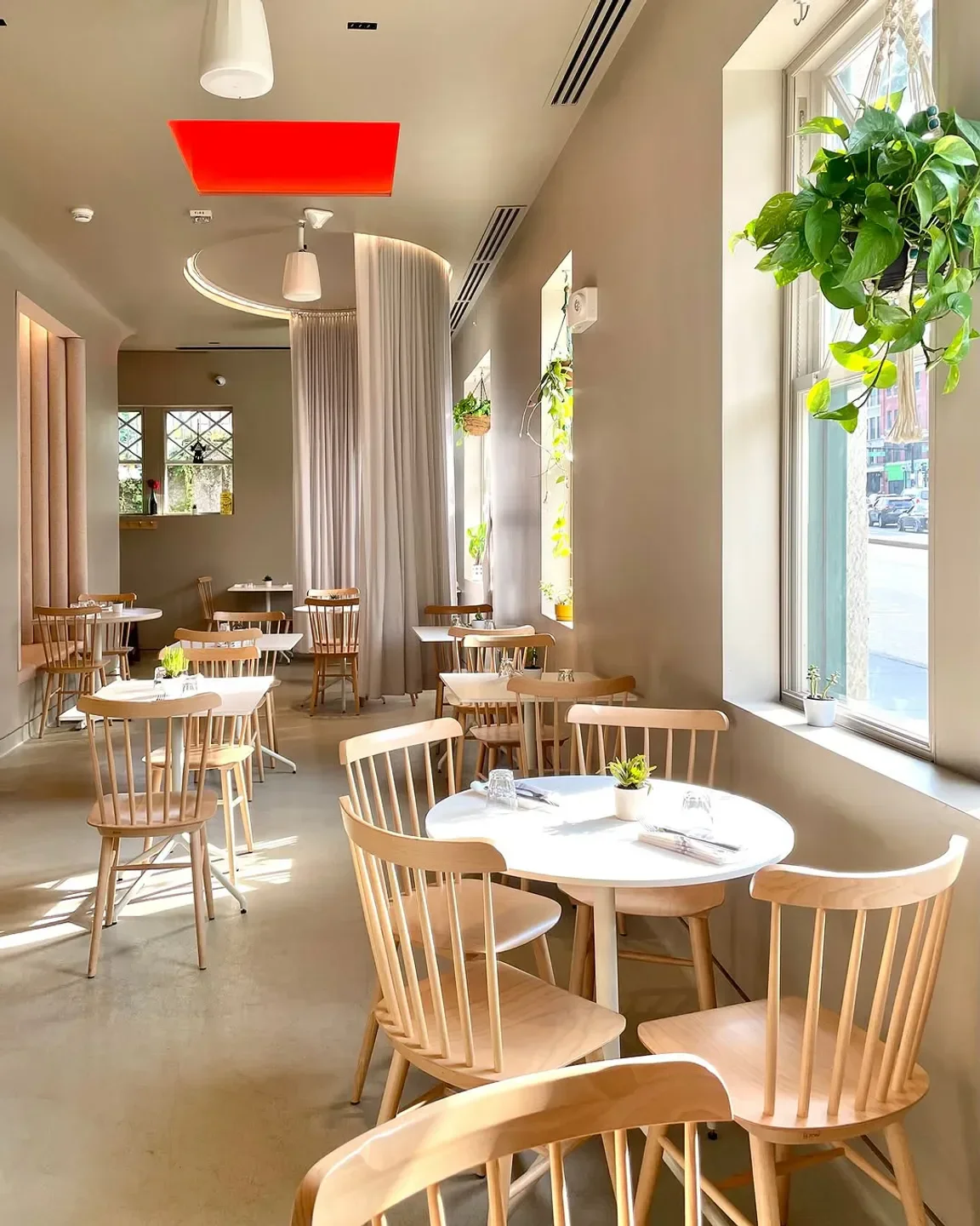 Comfort Kitchen in Boston: Bright and airy interior with wooden chairs and tables.