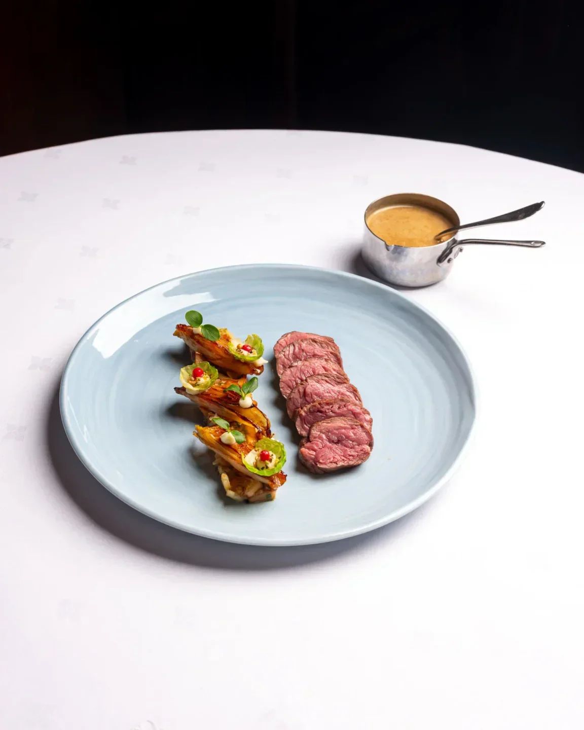 Elegant dish at Comme Chez Soi restaurant in Brussels: steak and creative appetizers.