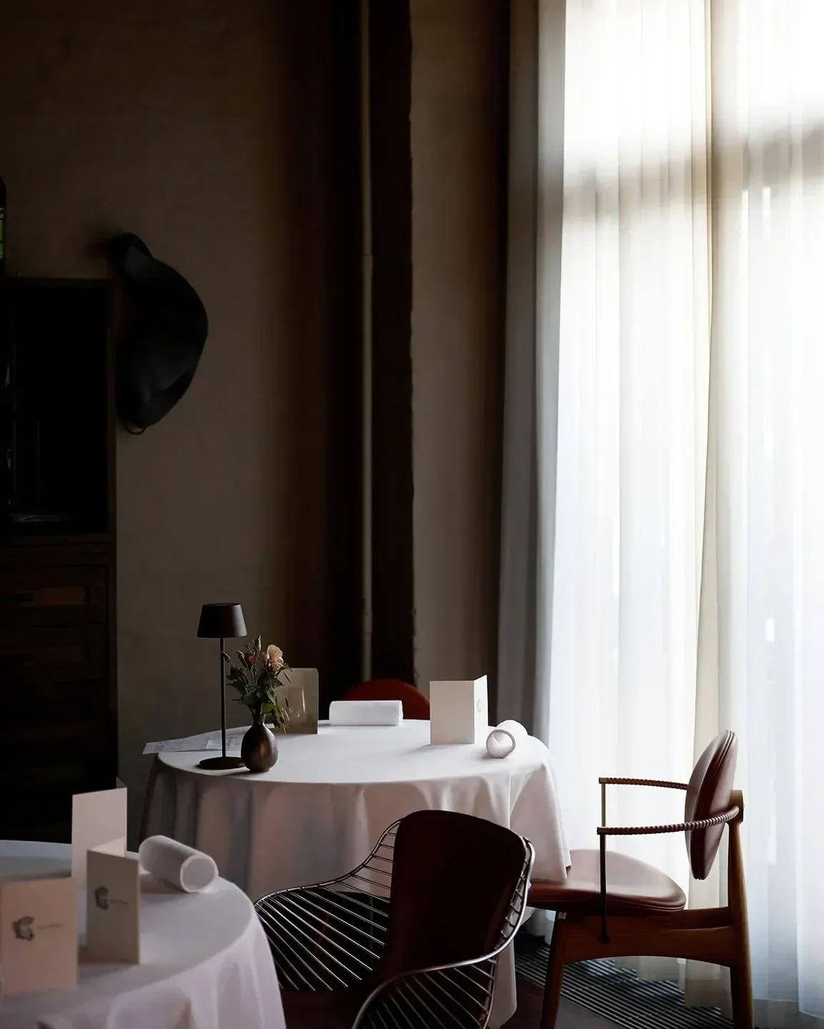 Interior of Connection by Alan Bates restaurant in Copenhagen, featuring tables and natural light.