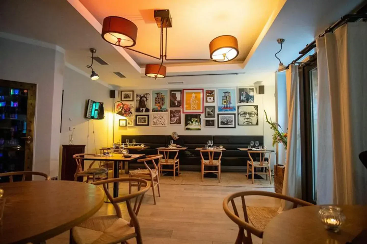 Elegant dining area at Cordo restaurant in Berlin with wall art and warm lighting.