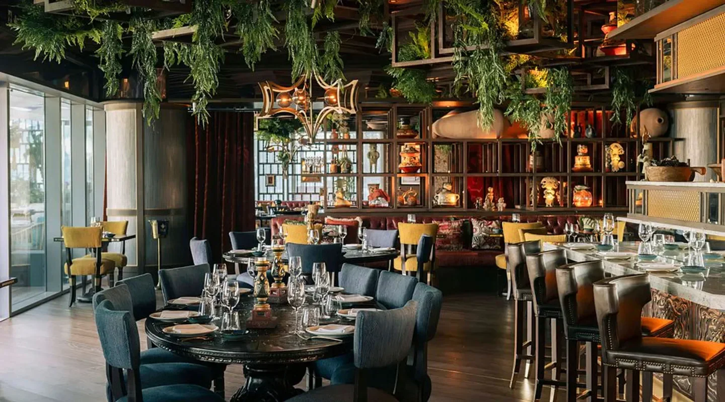 Elegant dining area at COYA Barcelona, featuring lush decor and stylish seating