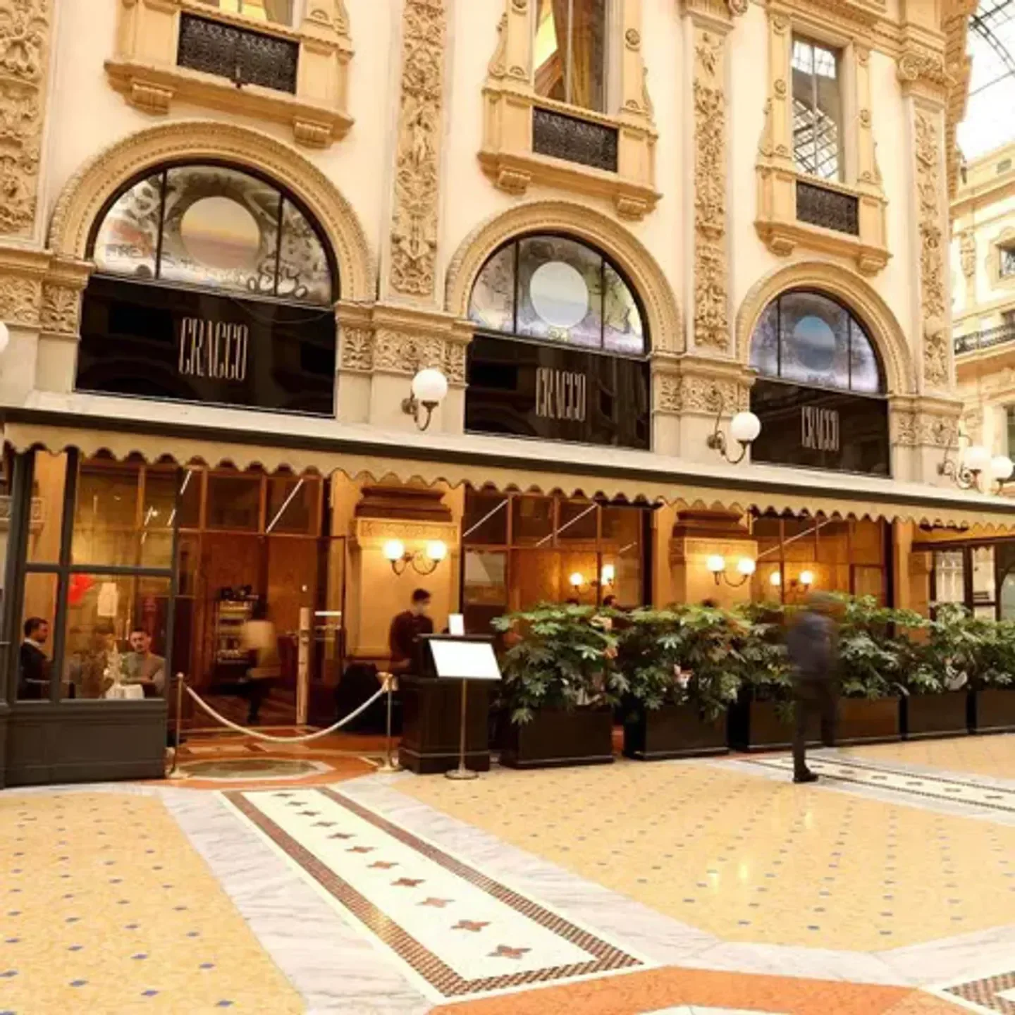 Exterior view of Cracco in Galleria restaurant in Milan, showcasing ornate architecture.