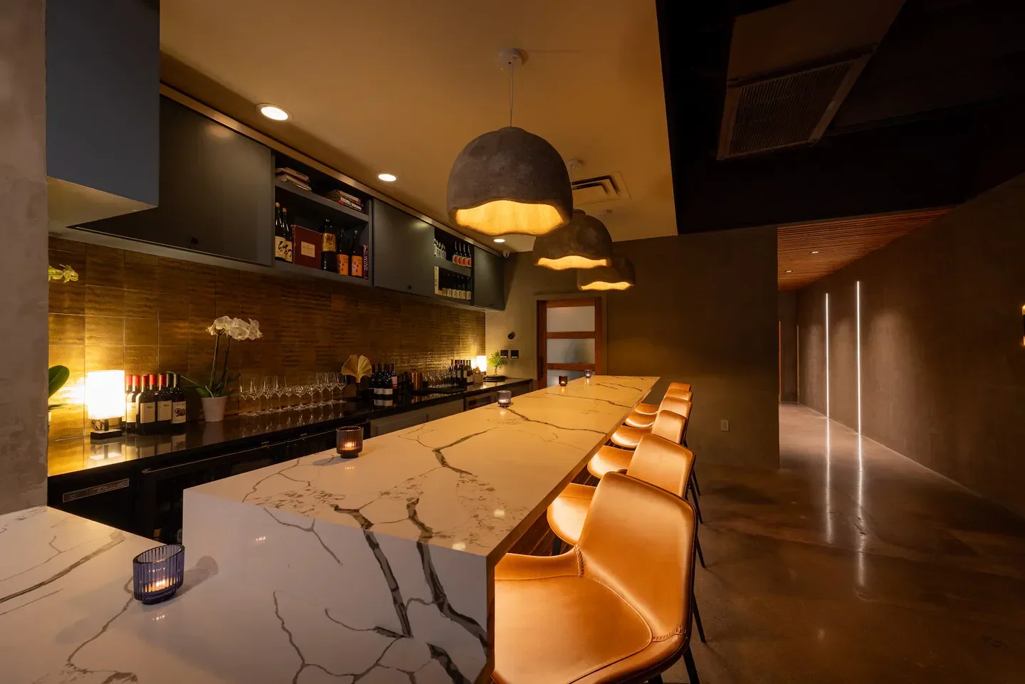 Interior of Craft Omakase in Austin, featuring a marble bar and stylish seating