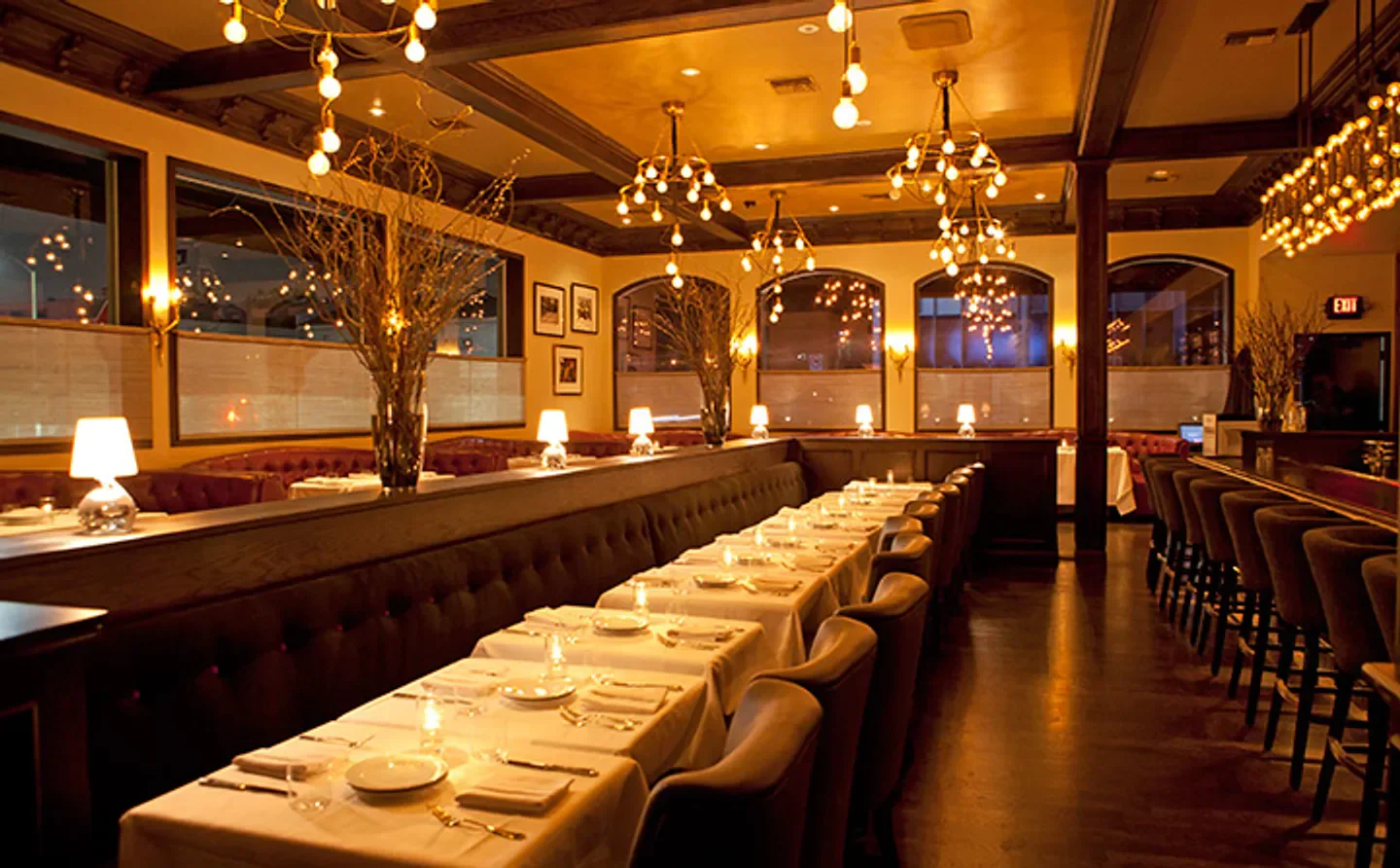 Elegant dining room interior at Crossroads Kitchen in Los Angeles, featuring chandeliers and tables