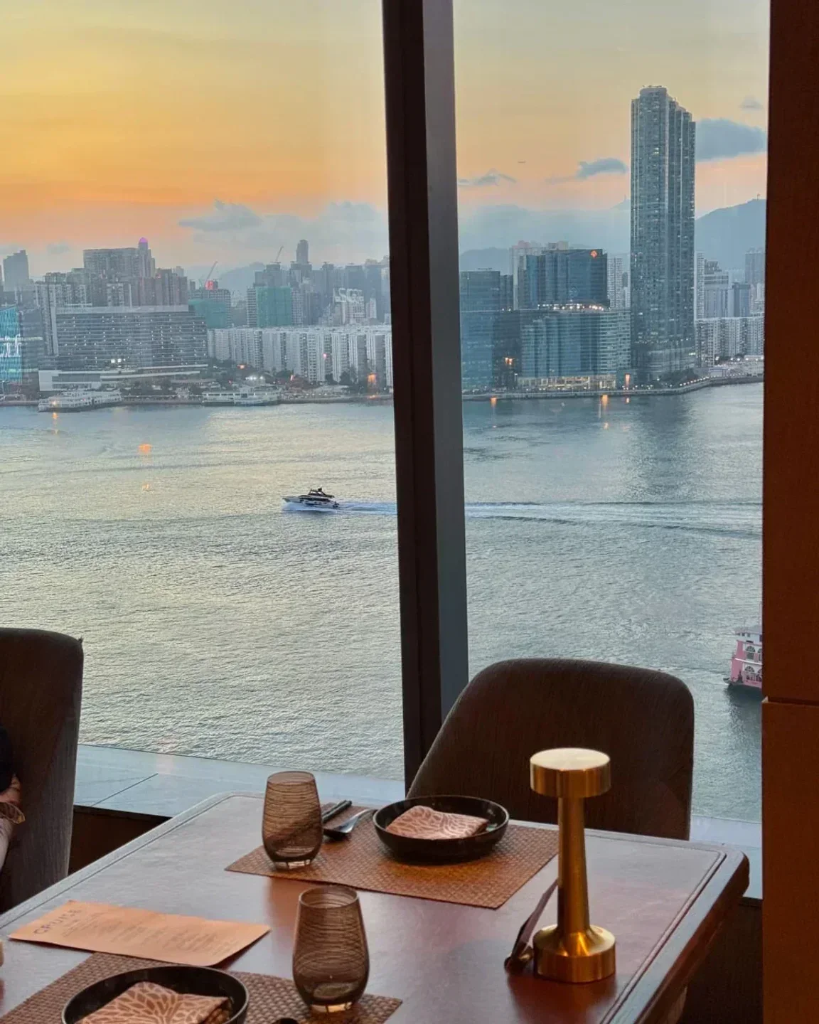 Table setting at CRUISE restaurant in Hong Kong with harbor view at sunset