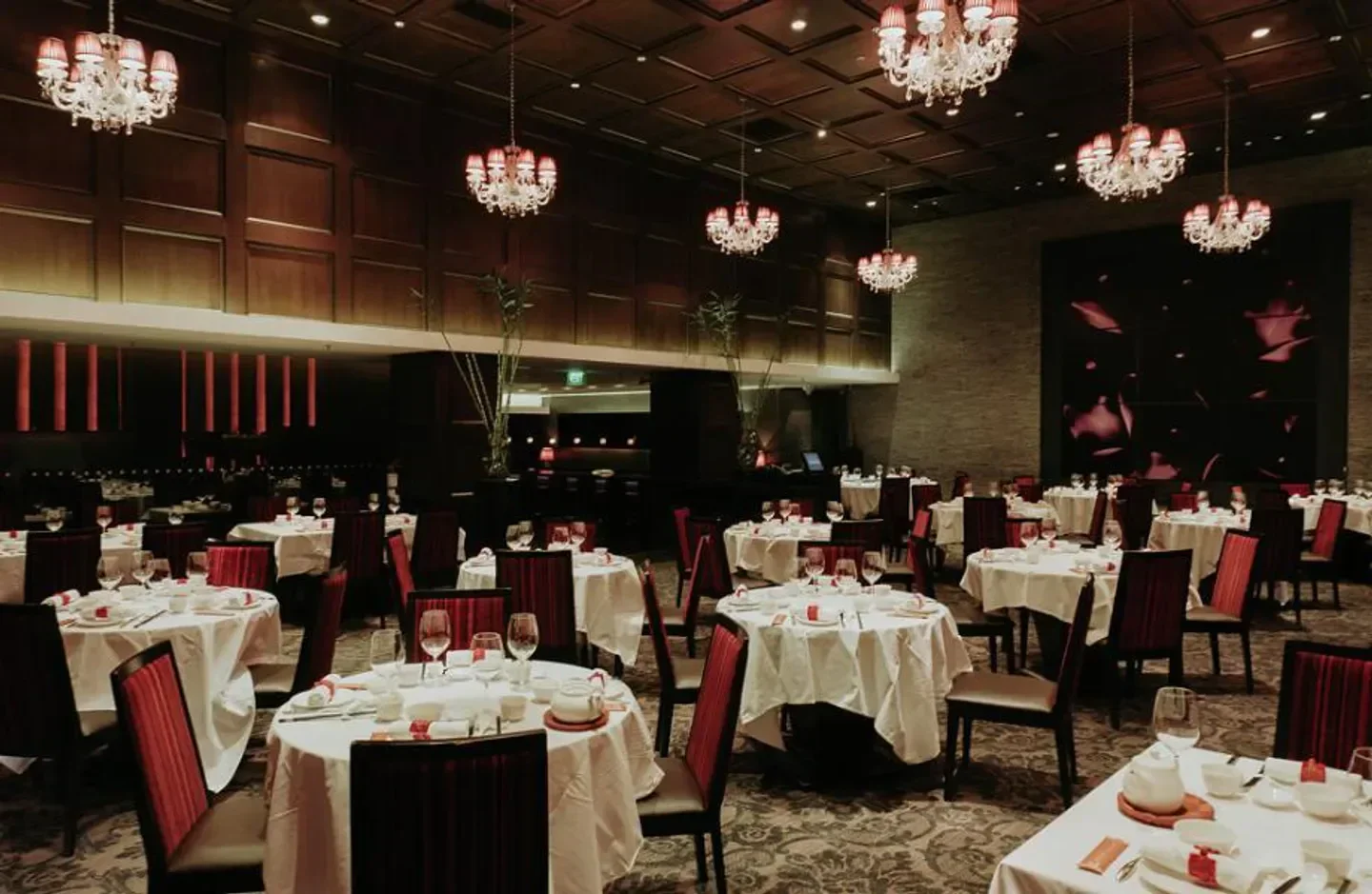 Elegant dining room at Crystal Jade Golden Palace restaurant in Singapore with chandeliers.