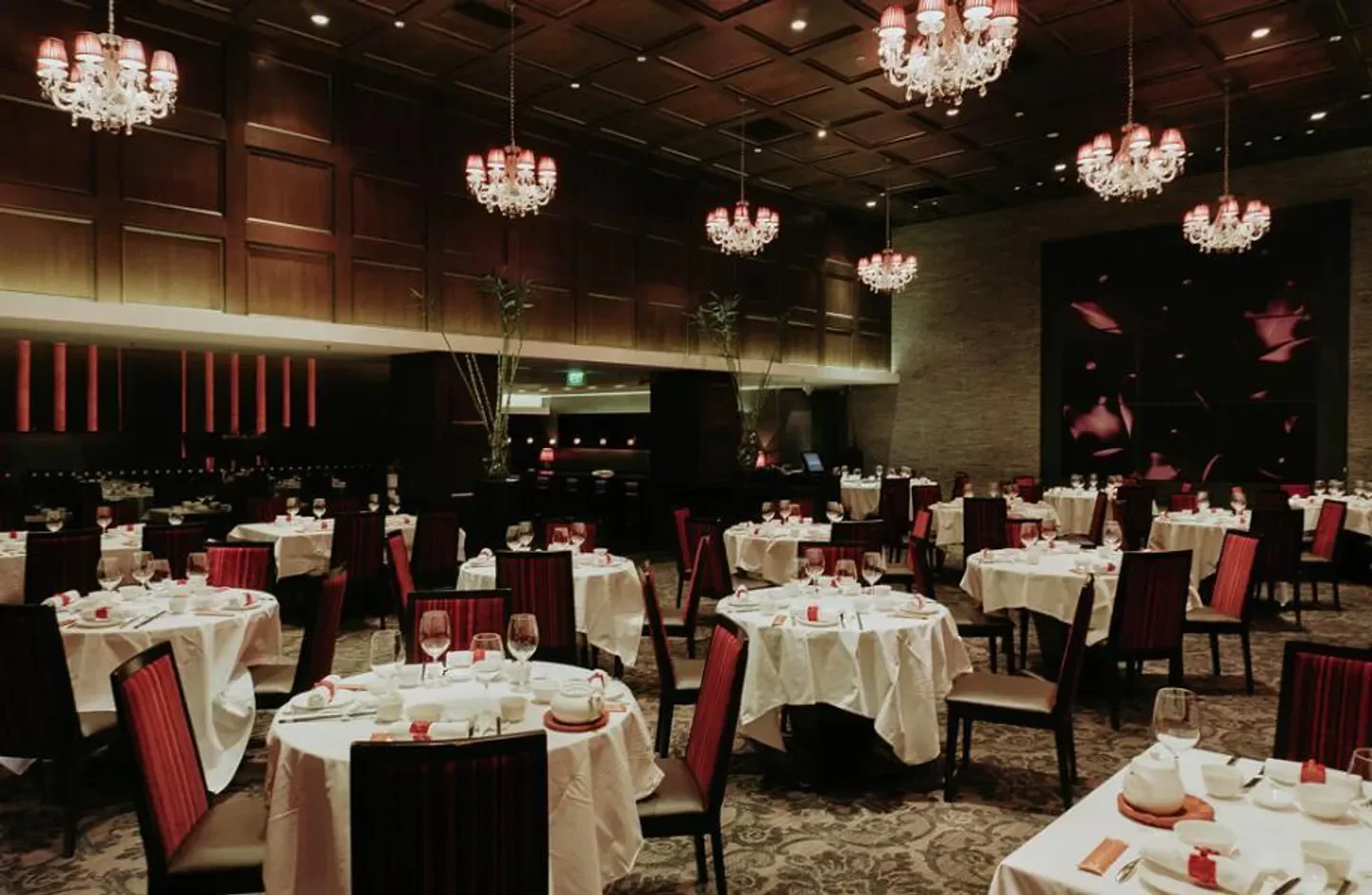Elegant dining room at Crystal Jade Golden Palace restaurant in Singapore with chandeliers.