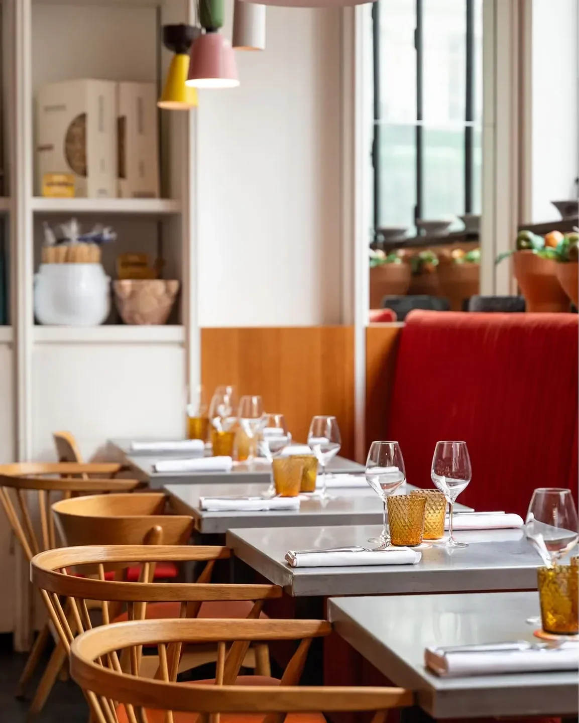 Cozy dining room at Cucina Mutualité in Paris, featuring stylish tables and chairs.