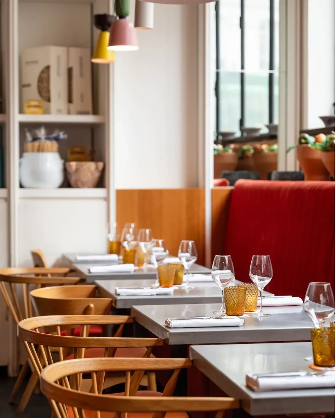 Cozy dining room at Cucina Mutualité in Paris, featuring stylish tables and chairs.