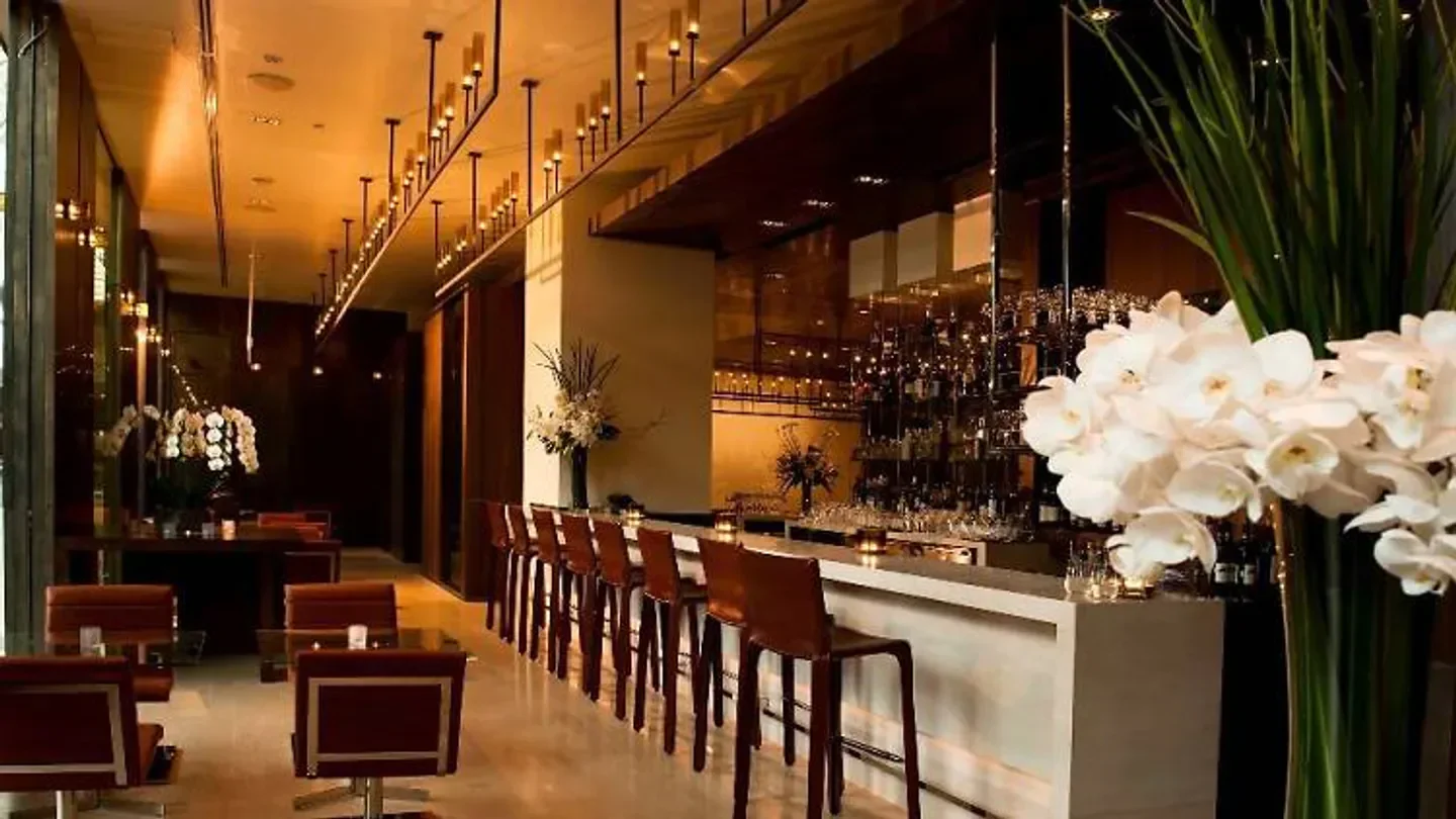Interior of CUT Singapore restaurant in Singapore, showcasing bar and elegant seating.
