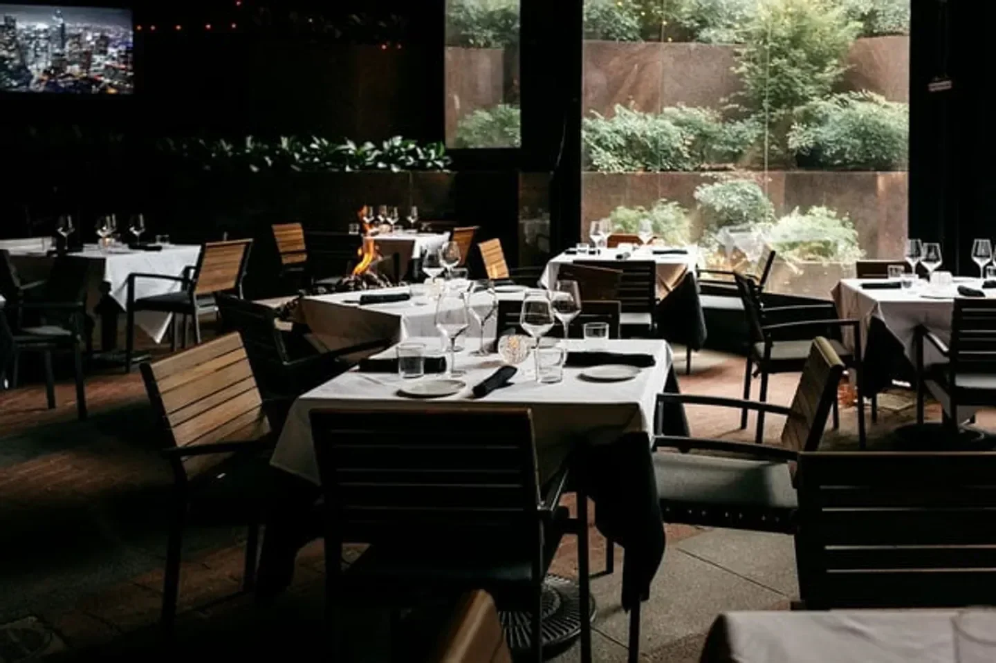 Cozy dining area at Dakota's Steakhouse in Dallas, with tables set for a perfect dinner.
