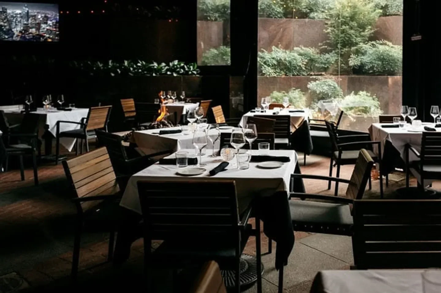 Cozy dining area at Dakota's Steakhouse in Dallas, with tables set for a perfect dinner.