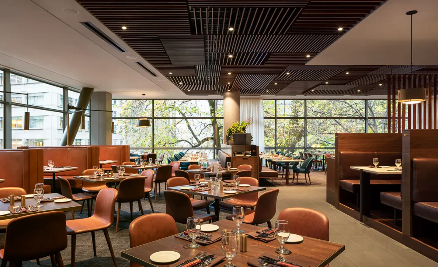 Interior of Daniel’s Broiler in Seattle, featuring tables set for dining in a stylish setting.