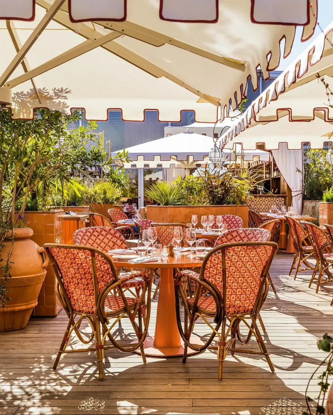 Outdoor dining at Dar Mima restaurant in Paris, featuring stylish patterned chairs and tables.