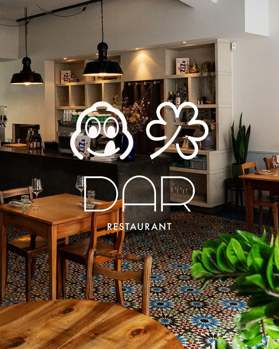 Cozy interior of DAR Restaurant in Zurich, featuring tables, chairs, and stylish decor.