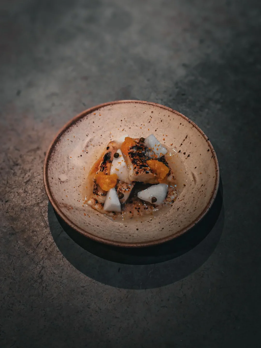 Dashi restaurant's signature dish with grilled fish, citrus, and herbs in the city.
