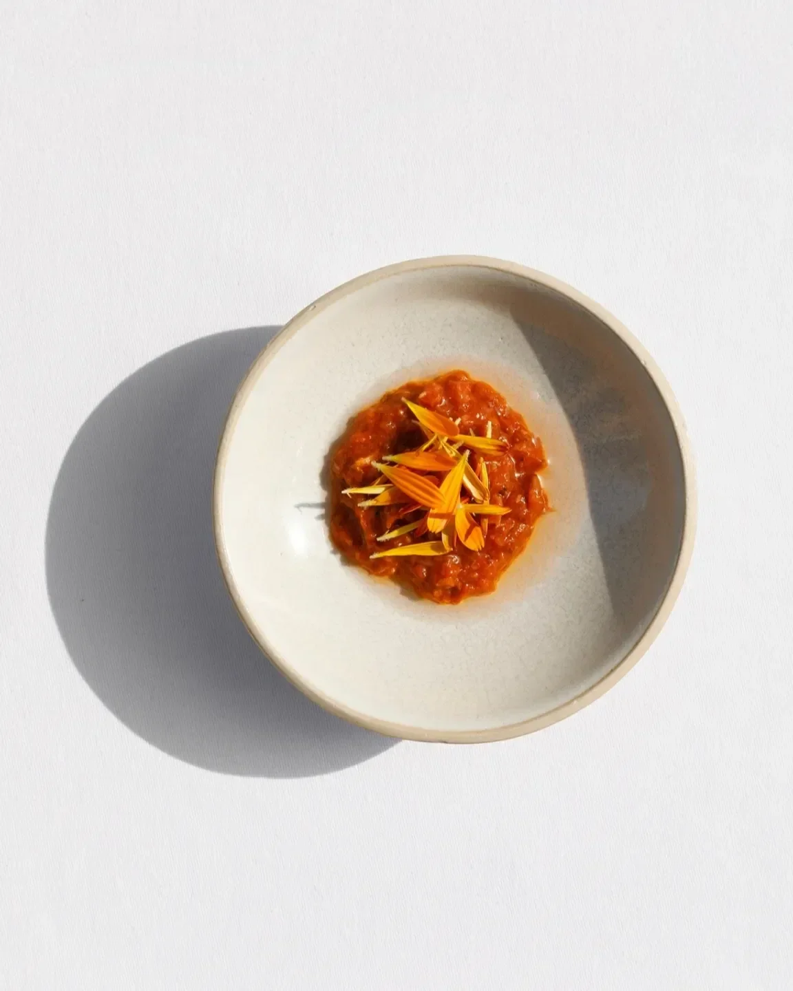 Delicious dish from Datil restaurant in Paris, featuring orange garnish and a white bowl.
