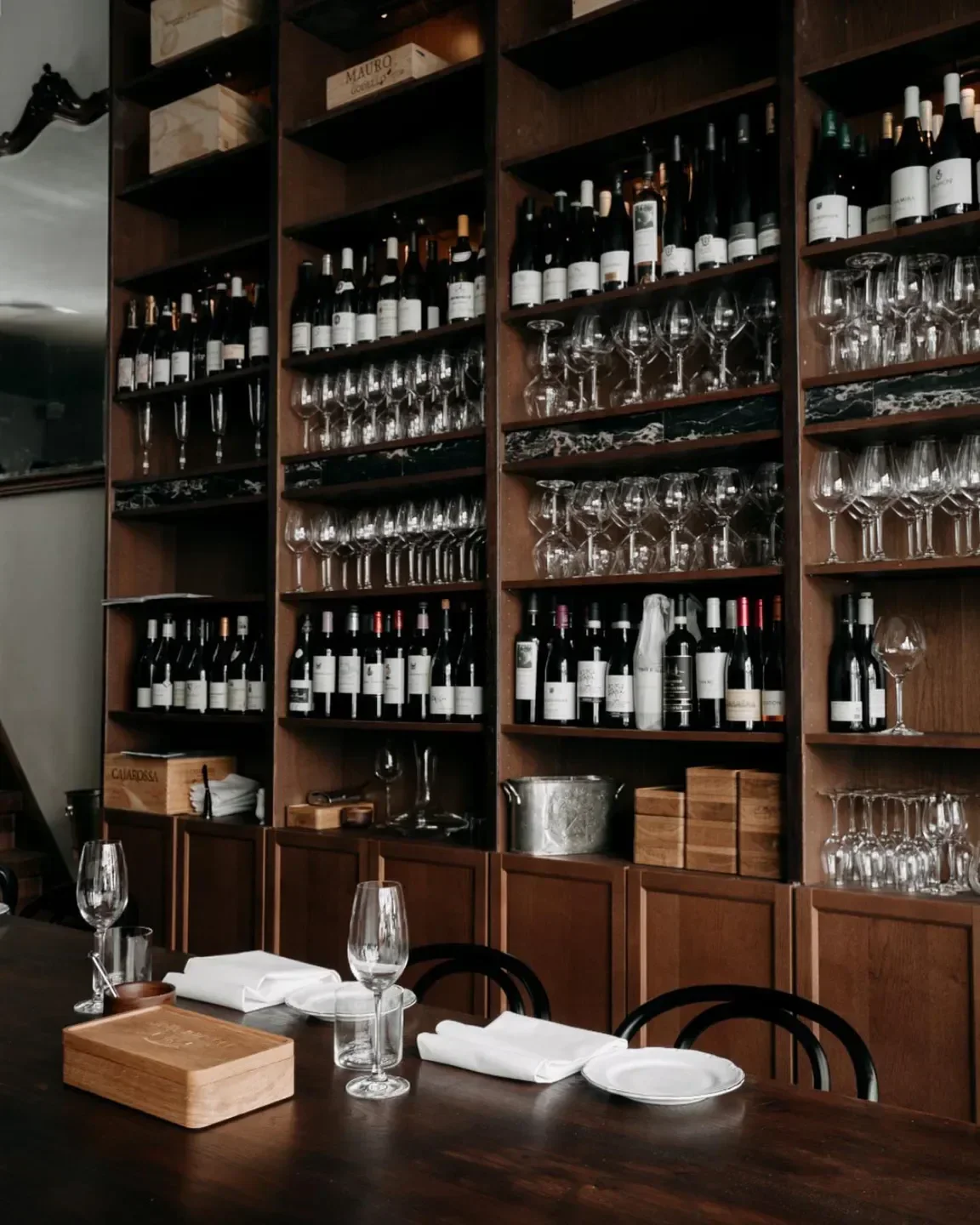 Interior view of De Juwelier in Amsterdam, showcasing wine and glassware display.