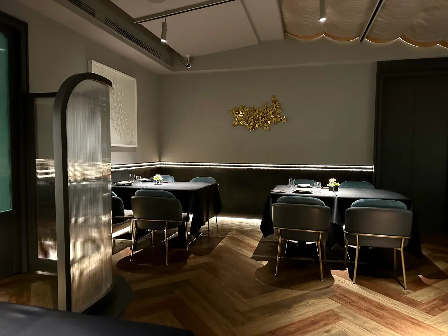 Interior of De Nuit in Taipei, featuring elegant dining tables and stylish decor.