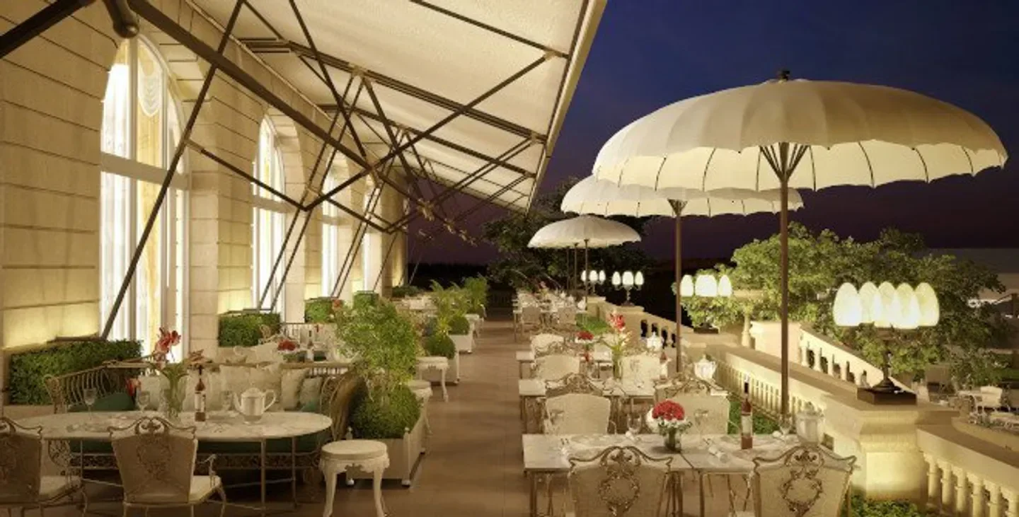 Elegant outdoor dining at Deessa restaurant in Madrid, featuring white umbrellas and tables