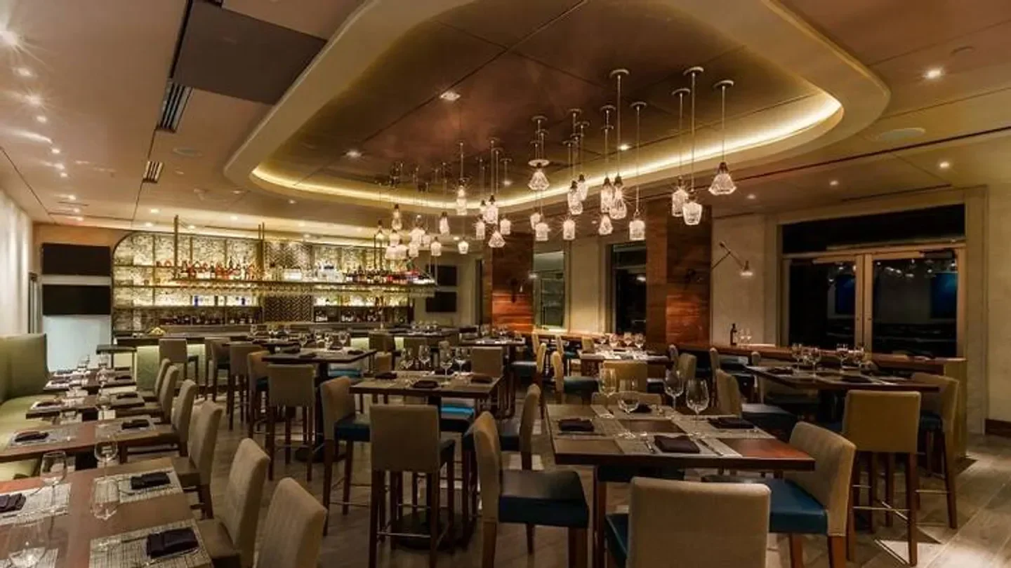 Interior of Del Frisco's Double Eagle Steakhouse in Orlando with hanging lights.