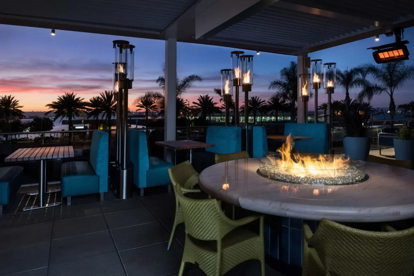 Outdoor patio at Del Frisco's Double Eagle Steakhouse - San Diego at sunset with fire pit.