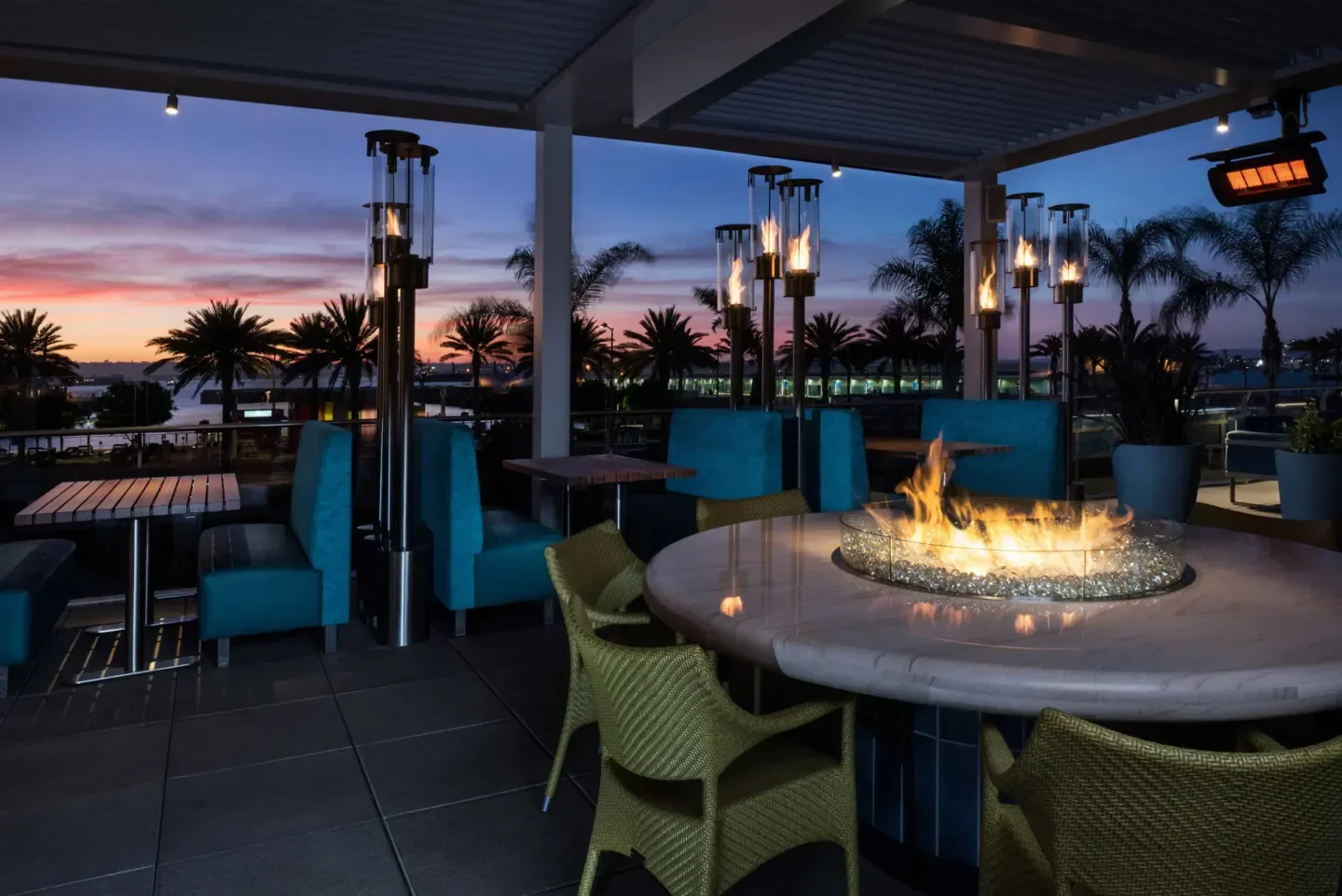 Outdoor patio at Del Frisco's Double Eagle Steakhouse - San Diego at sunset with fire pit.