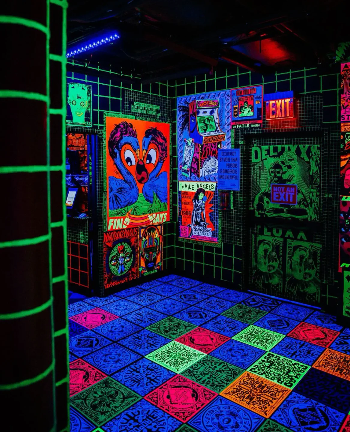 Vibrant blacklight interior of Deluxx Fluxx nightclub, featuring psychedelic posters and a glowing tiled floor in the city.