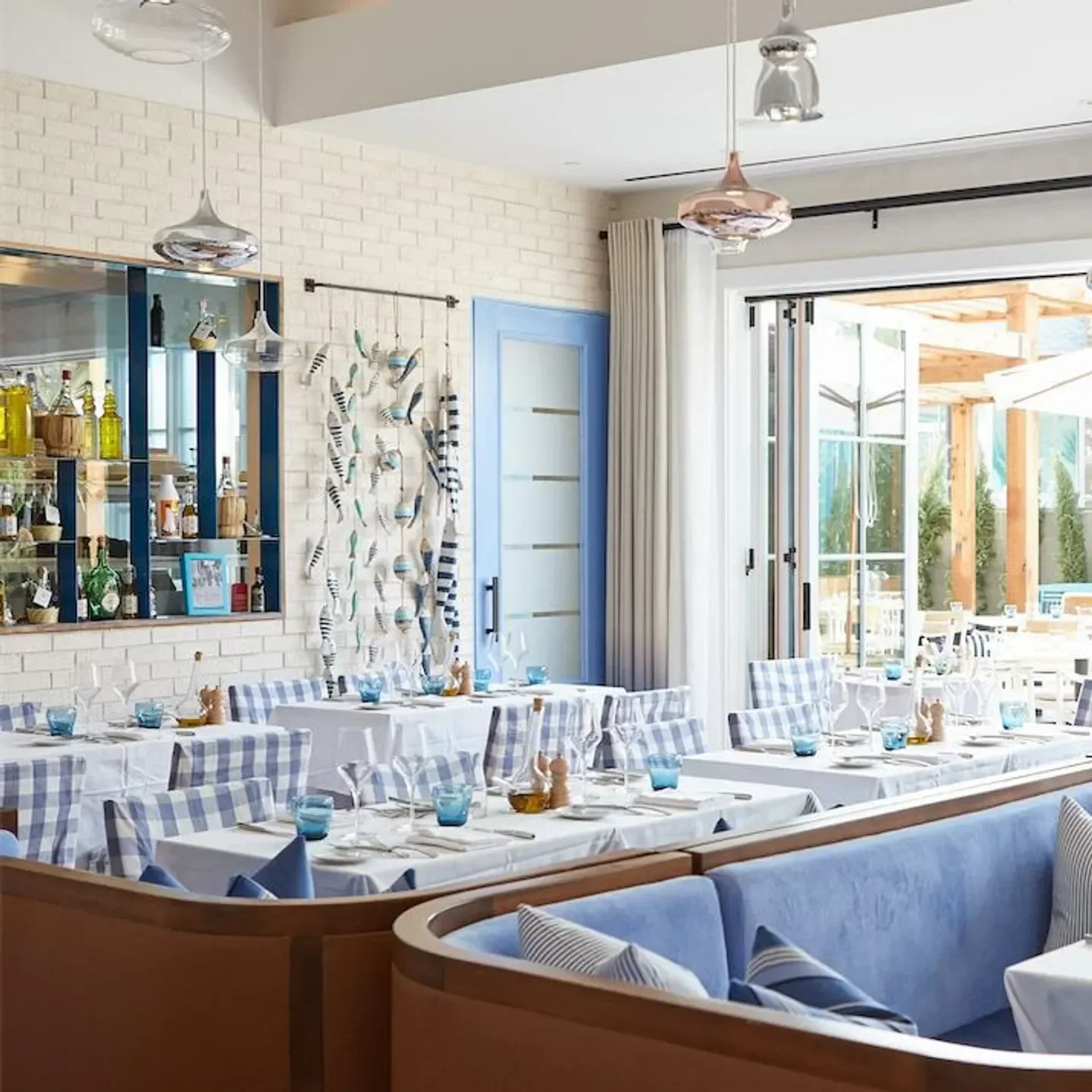 Interior of Dolce Riviera in Dallas, featuring stylish seating and elegant table settings.