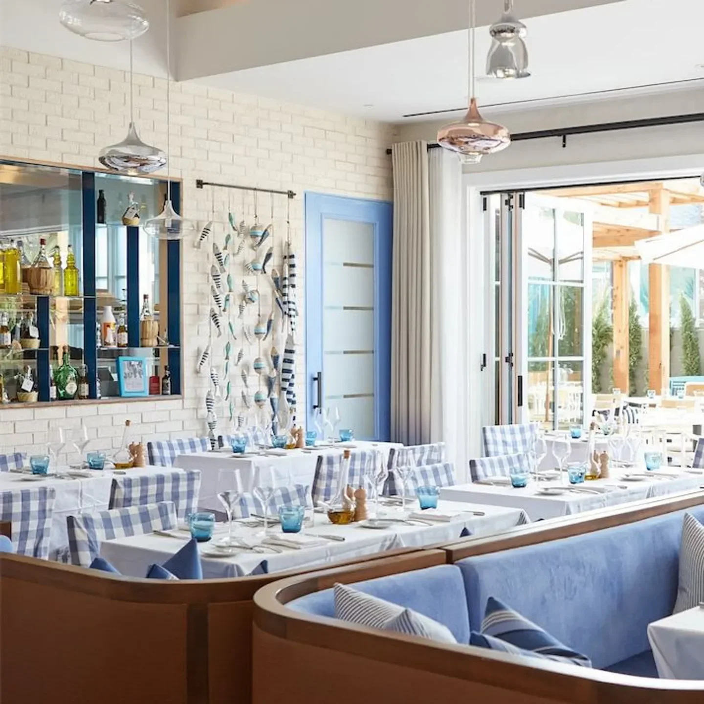 Interior of Dolce Riviera in Dallas, featuring stylish seating and elegant table settings.