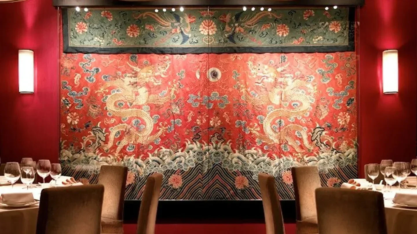 Interior of Dong Lai Shun restaurant in Hong Kong featuring ornate wall decor and dining tables