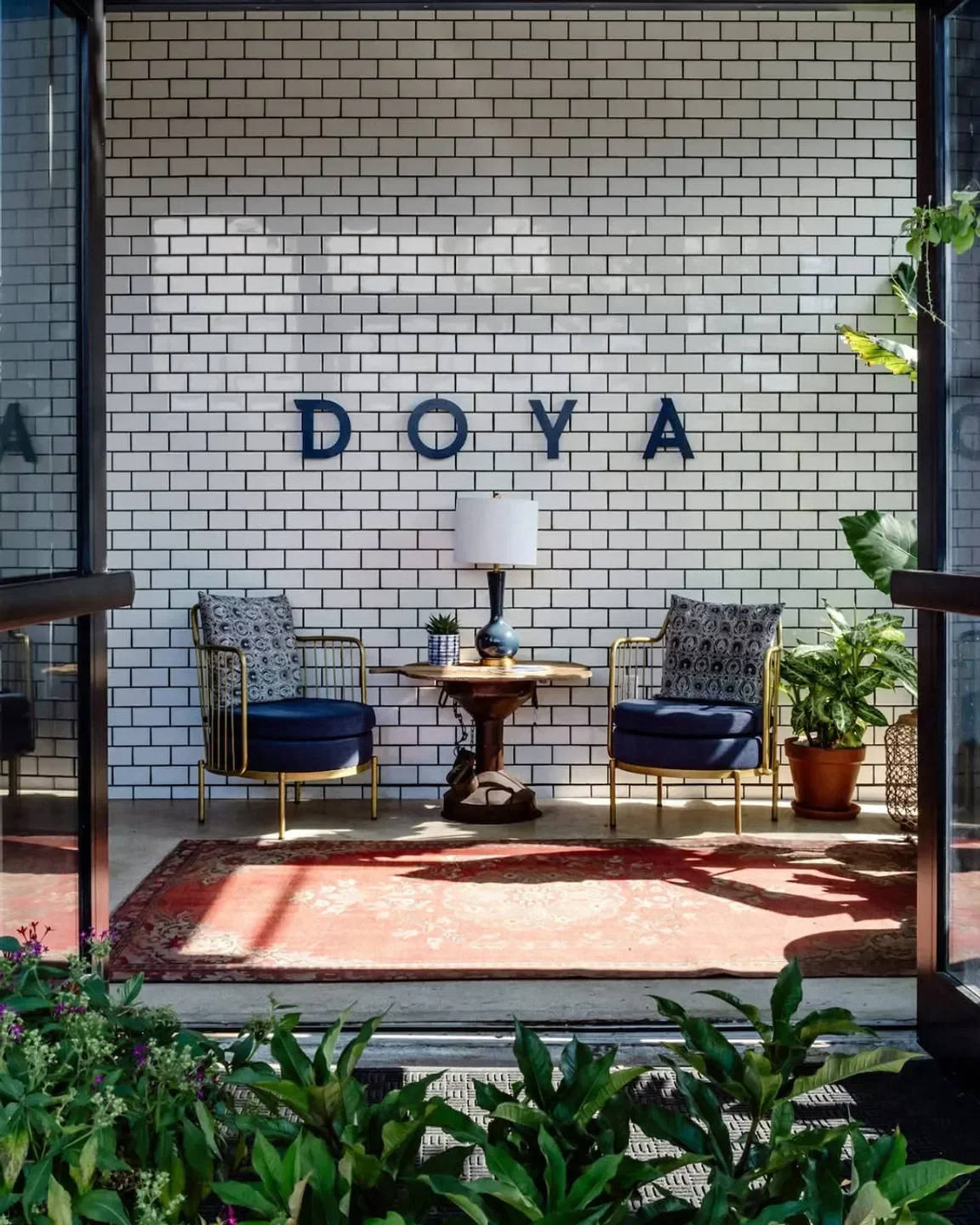 Cozy seating area at DOYA Miami, with stylish chairs and rug.