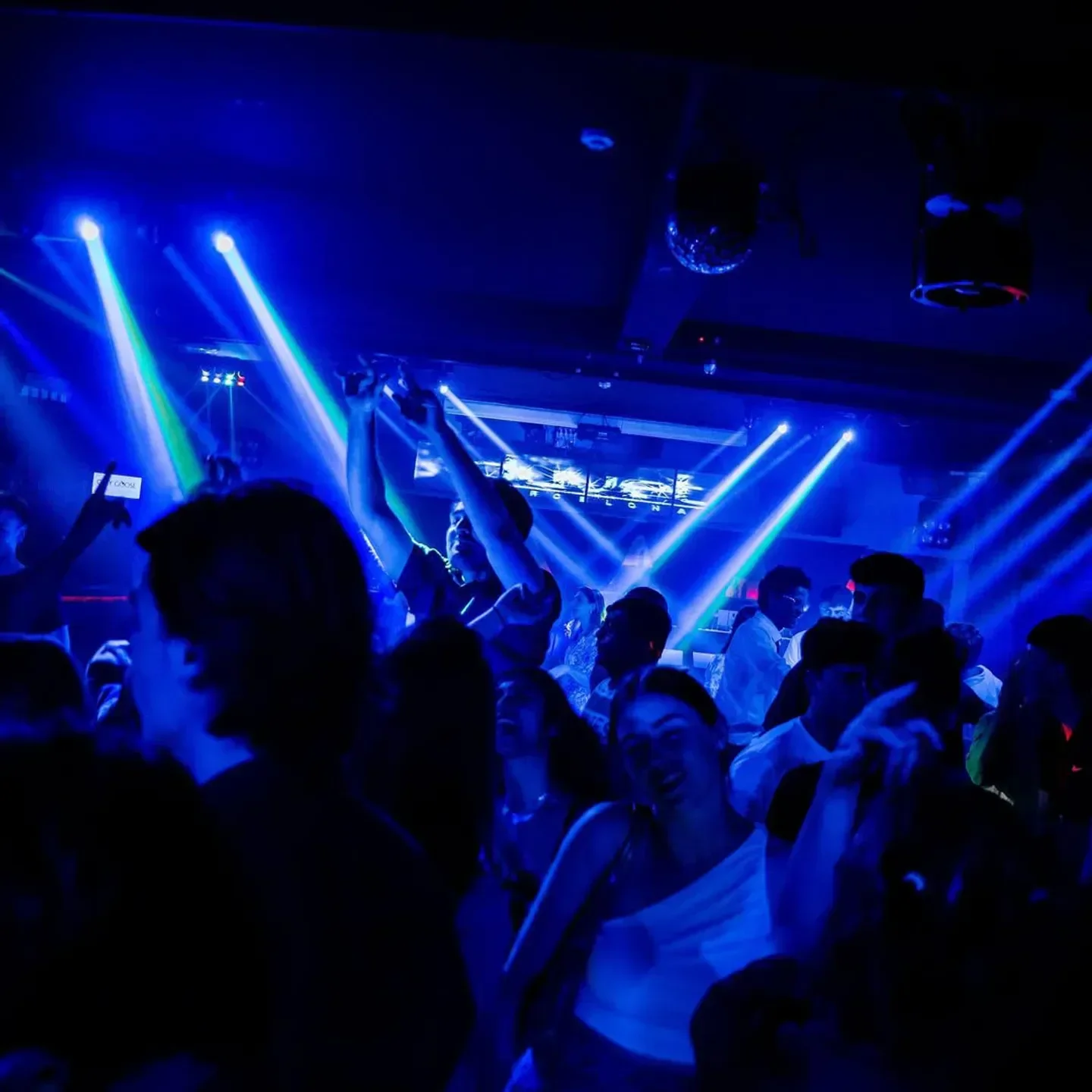 Duvet nightclub in Barcelona with a crowd dancing under blue lights.