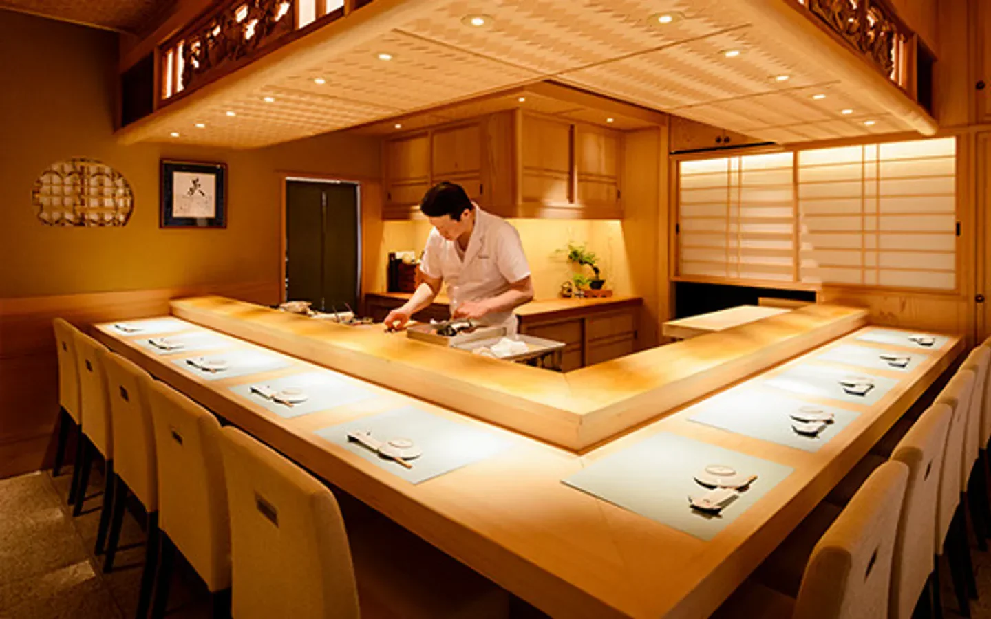 Chef preparing sushi at Edomae Sushi Hanabusa in Tokyo, Japan, restaurant interior.