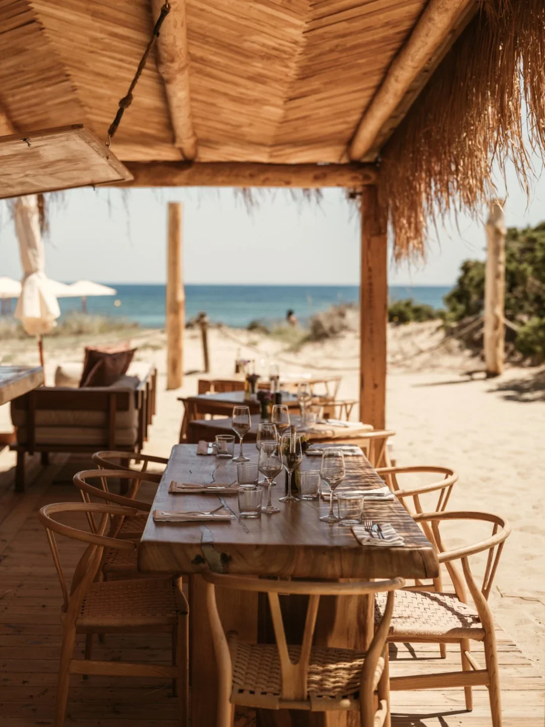 El Chiringuito restaurant's rustic beachside dining with wooden tables and ocean views