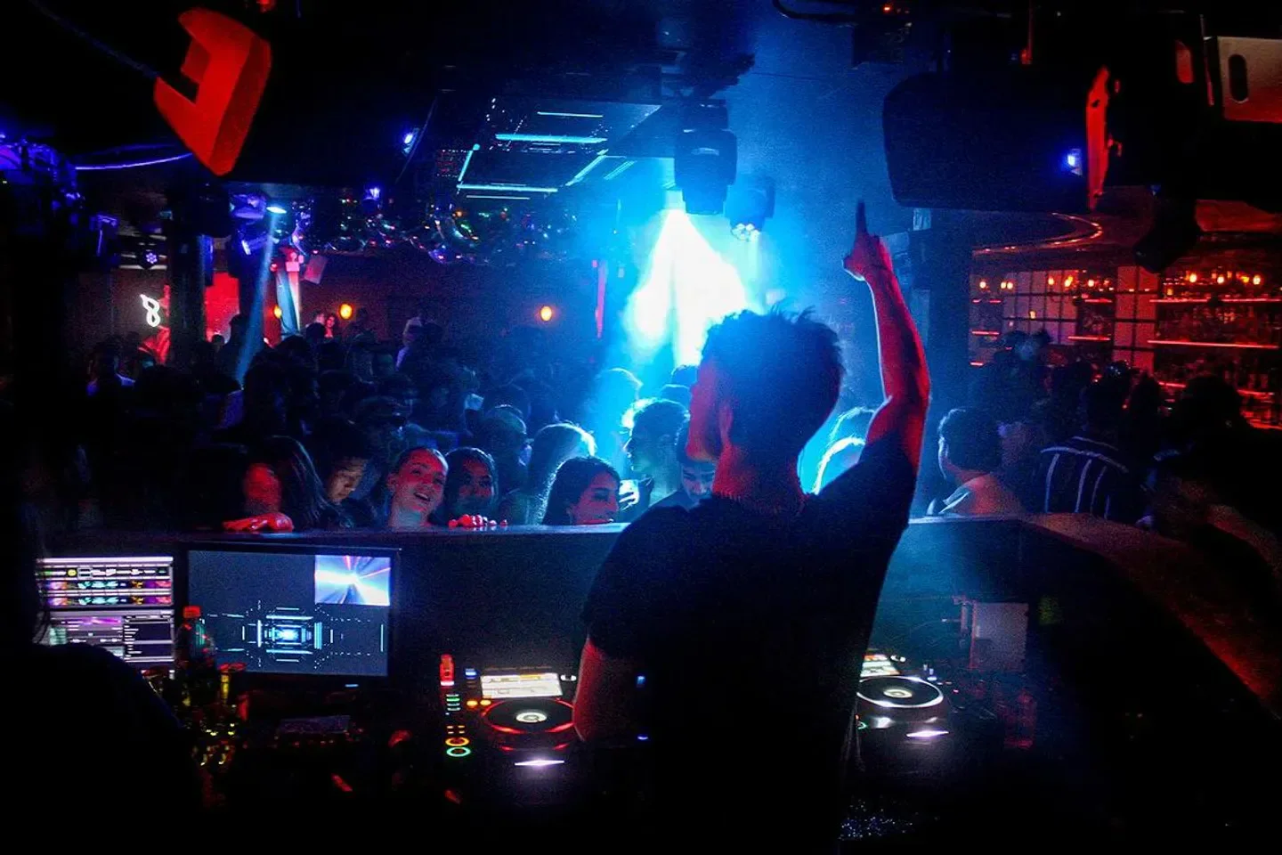 DJ at Electric Hotel in Chicago, pointing up to the crowd during a lively nightclub event.