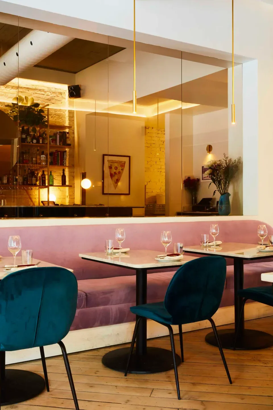 Interior of Elena restaurant in Montreal, featuring velvet chairs and tables.