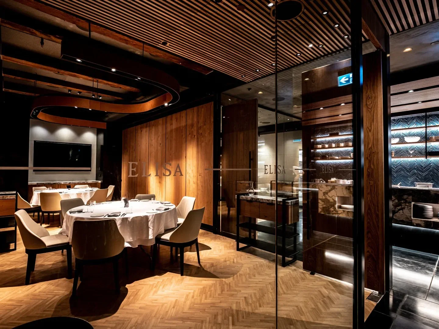 Interior of Elisa restaurant in Vancouver, featuring elegant dining tables and decor.