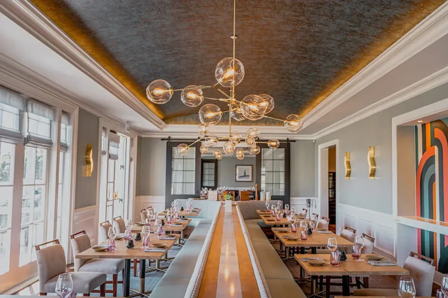 Dining area at Ember & Rye in San Diego, featuring a unique chandelier and decor.
