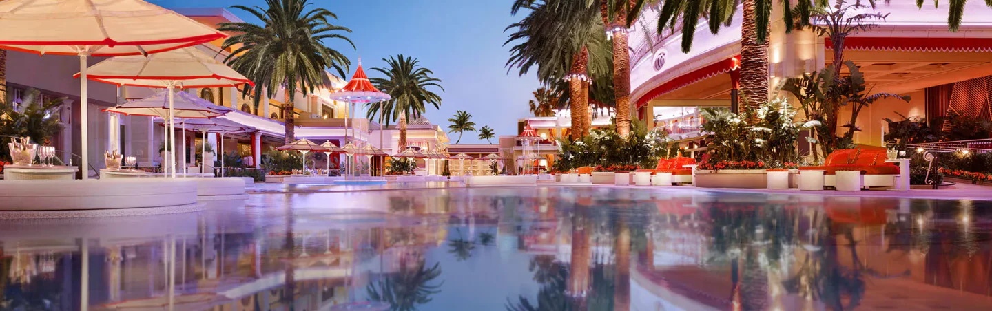 Encore Beach Club at Night in Las Vegas, featuring poolside seating, palm trees, and vibrant evening ambiance.