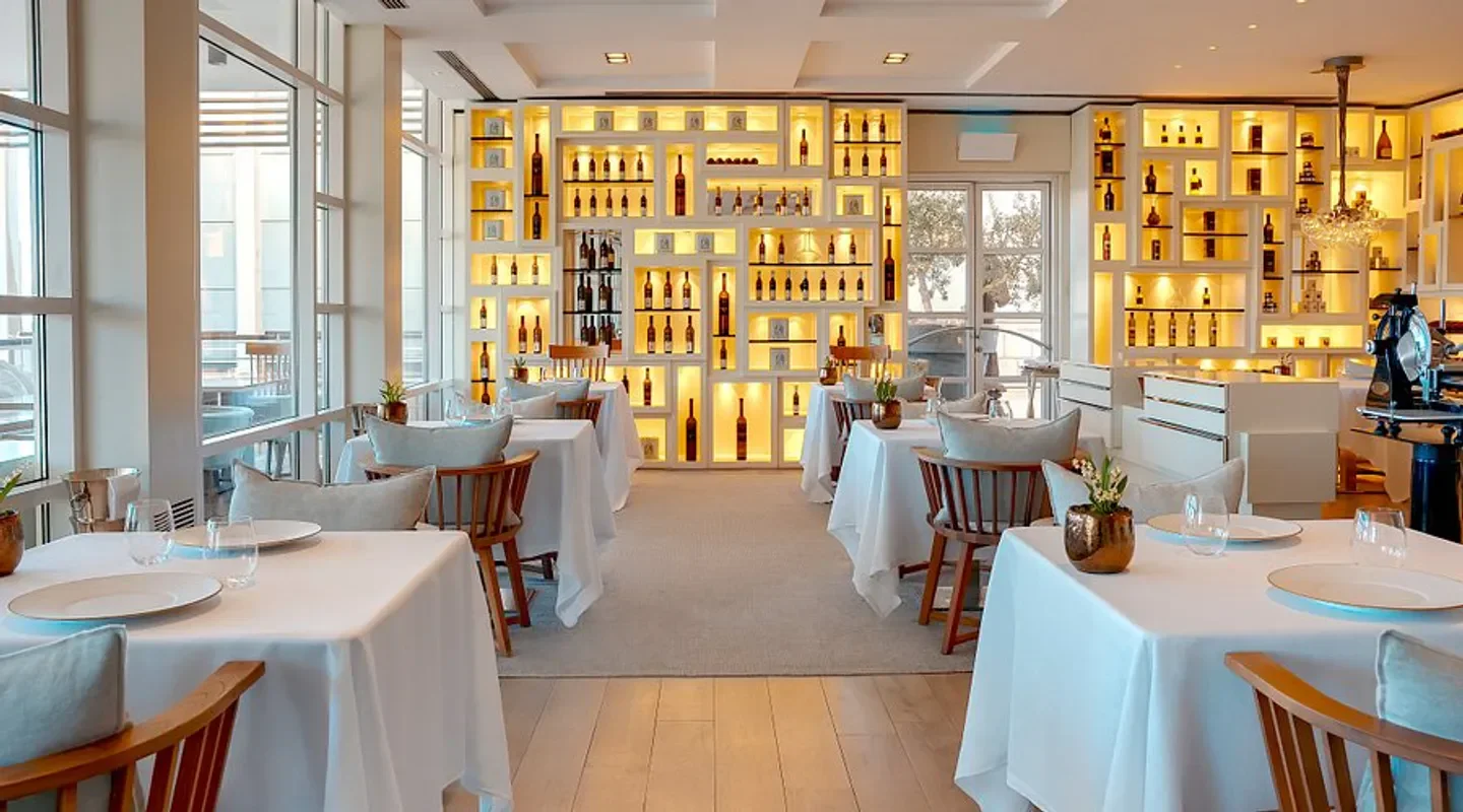 Elegant dining room interior at Enoteca Paco Pérez in Barcelona, featuring wine display.