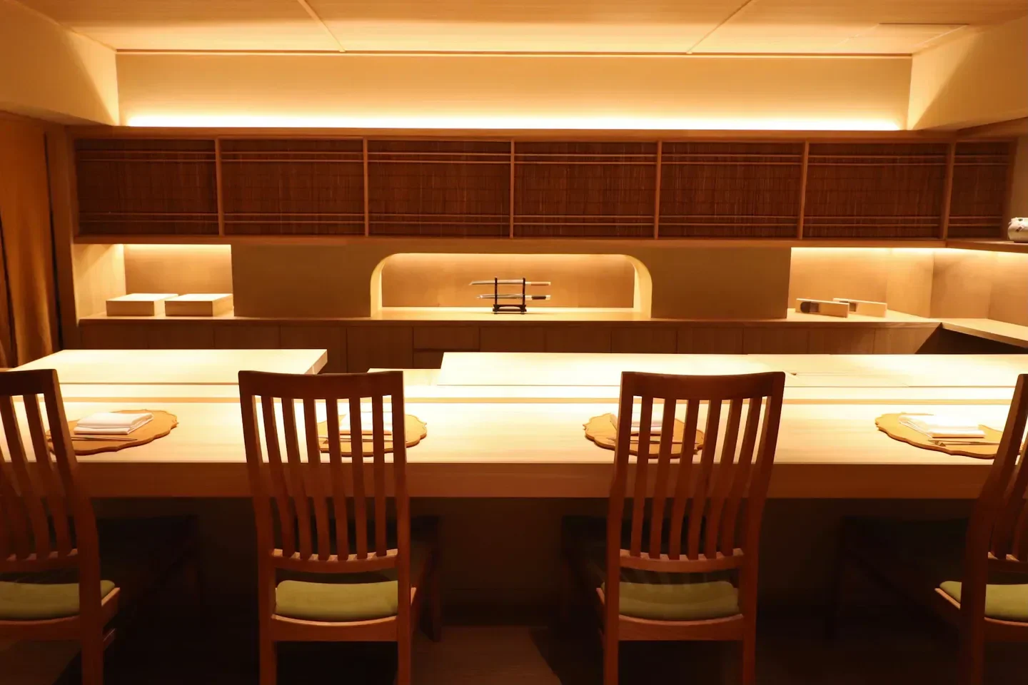 Elegant dining space at Ensui restaurant in Tokyo, showcasing minimalist design and wooden chairs