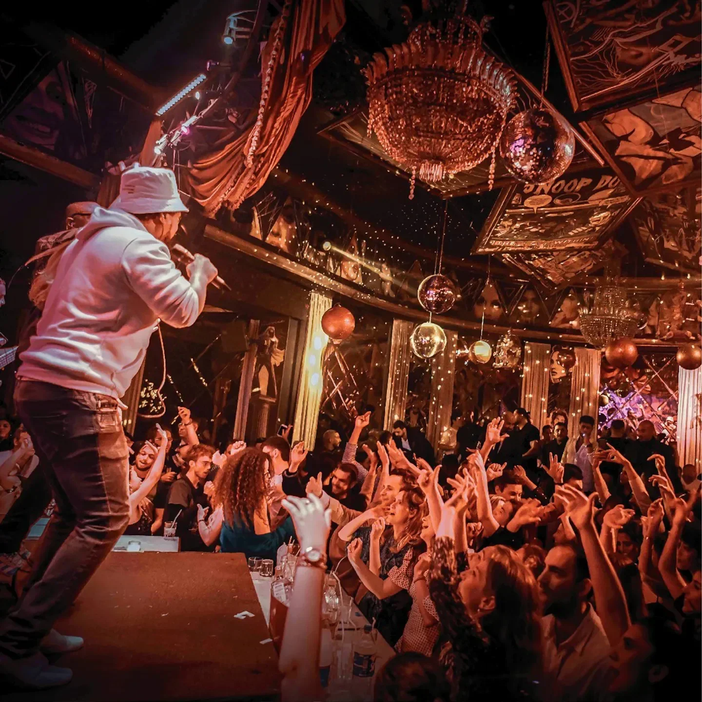 Energetic crowd at Epicurien nightclub in Marrakech, enjoying live music and a vibrant atmosphere