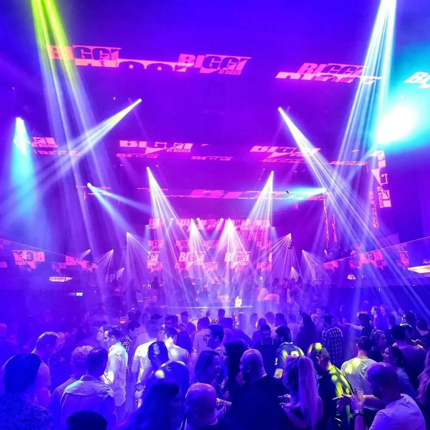 Energetic nightclub scene at Escape Amsterdam, with stage lights and a lively crowd.