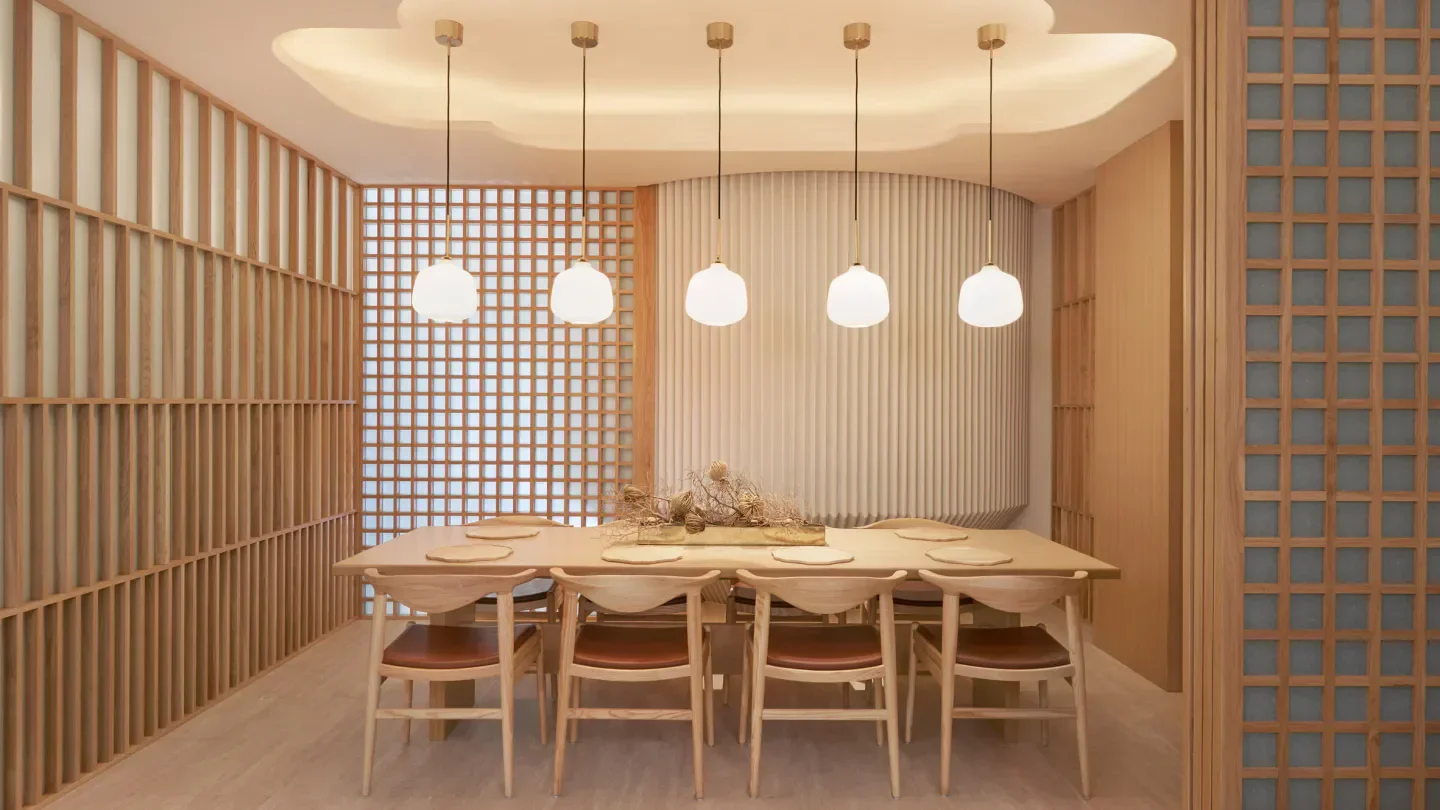 Elegant dining space at Esora restaurant in Singapore, featuring wooden decor and lighting.